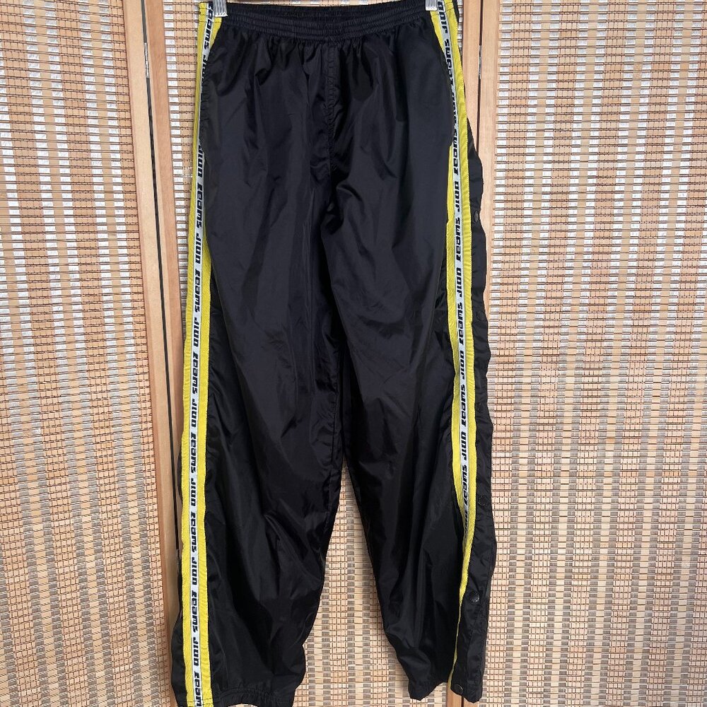 Black and yellow UNIF breakaway swishy pants with pockets and stretchy waist